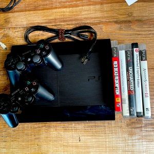 PlayStation 3 500GB Slim with 2 original controllers and five used PS3 games